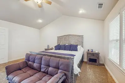 a bedroom with a bed and a couch at Walk to Lake Arrowhead! Family Home with Games in Lake Arrowhead