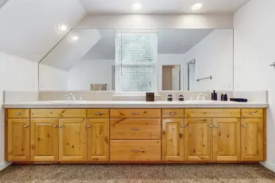 a bathroom with a large sink and a large mirror at Walk to Lake Arrowhead! Family Home with Games in Lake Arrowhead