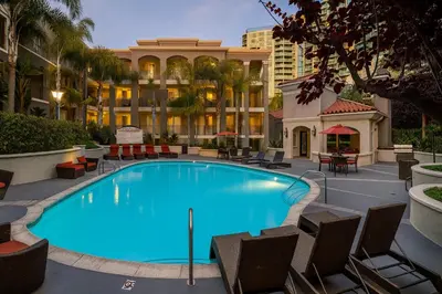 a large swimming pool with chairs and a building at Beachside Marina Del Rey 2BR & 1BR - Resort Amenities in Los Angeles