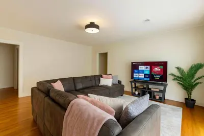 a living room with a couch and a flat screen tv at Fullerton Family-Ready- 9 min to Disneyland in Fullerton