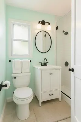a bathroom with a toilet and a sink and a mirror at Fullerton Adventure Pad - 10 min to Disneyland in Fullerton
