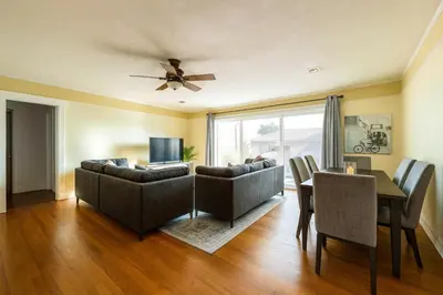 a living room with a couch and a table and a ceiling fan at Fullerton Adventure Pad - 10 min to Disneyland in Fullerton