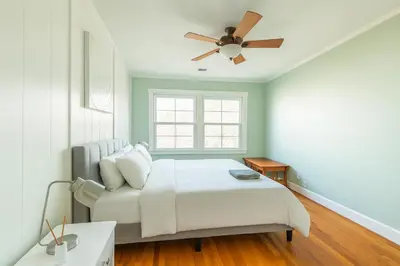 a bedroom with a bed and a ceiling fan at Fullerton Parkside Getaway - 13min to Disneyland in Fullerton