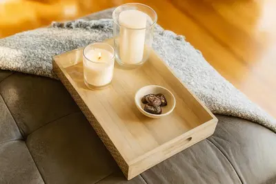 a wooden tray with candles and a bowl of food on a couch at Fullerton Parkside Getaway - 13min to Disneyland in Fullerton