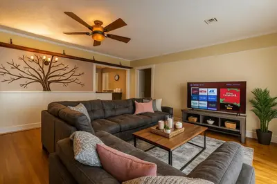 a living room with a couch and a flat screen tv at 4BR Fullerton Retreat - Private Backyard in Fullerton