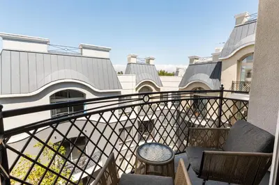 a balcony with two chairs and a table at Serene Zen Peaceful Zen Garden View with Pool Gym in Los Angeles