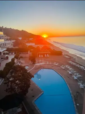 an aerial view of a resort with a pool and the beach at Oceanfront, Pool, Jacuzzi NO HWY Noise! in Malibu Beach