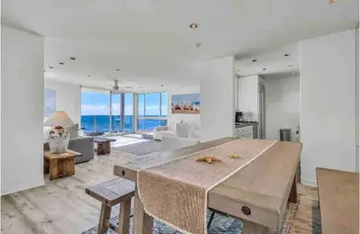 a large living room with a large wooden table and chairs at Oceanfront, Pool, Jacuzzi NO HWY Noise! in Malibu Beach