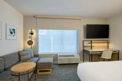 a living room with a couch and a tv at TownePlace Suites by Marriott Ridgecrest in Ridgecrest