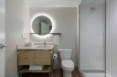 a bathroom with a toilet and a sink and a shower at TownePlace Suites by Marriott Ridgecrest in Ridgecrest