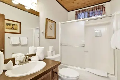 a bathroom with a sink and a toilet and a shower at Switzerland Summit Condo- Cozy Base Camp Resort Chalet- Walk to Ski Lifts + Hiking in Big Bear Lake