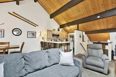 a living room with a gray couch and chairs at Switzerland Summit Condo- Cozy Base Camp Resort Chalet- Walk to Ski Lifts + Hiking in Big Bear Lake