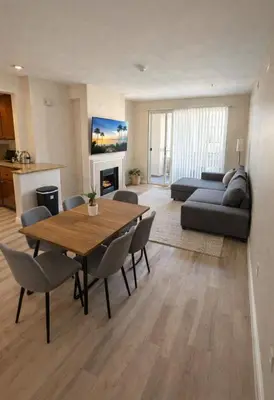 a living room with a table and chairs and a couch at Marina Del Rey Getaway - Resort Amenities in Marina del Rey in Los Angeles
