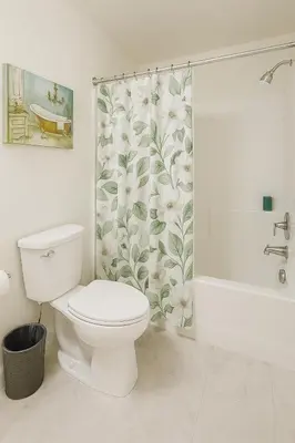 a bathroom with a toilet and a shower curtain at Marina Del Rey Getaway - Resort Amenities in Marina del Rey in Los Angeles