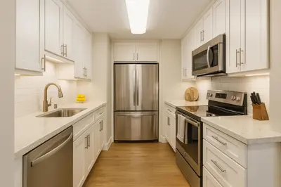 a kitchen with white cabinets and a stainless steel refrigerator at Marina Del Rey Getaway - Resort Amenities in Marina del Rey in Los Angeles