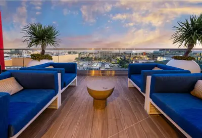 a balcony with blue couches and a view of a city at A Class Weho 2BD 2BA with Free Parking in Los Angeles
