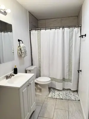 a bathroom with a toilet and a sink and a shower at The Maze House Pool Theatre Room in San Bernardino