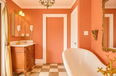 an orange bathroom with a tub and a sink at Luxe Homestay in Hollywood - by The Grove & Walk of Fame in Los Angeles
