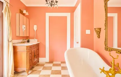 an orange bathroom with a tub and a sink at Iconic Hollywood Homestay Near Walk Of Fame in Los Angeles