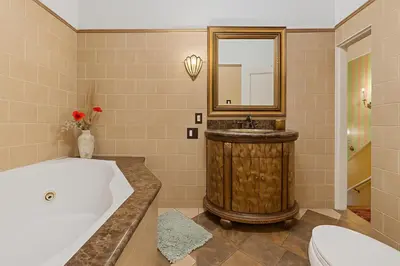 a bathroom with a tub and a sink and a mirror at Central Hollywood Homestay Getaway in Los Angeles