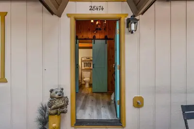 a teddy bear on the side of a house at Retro Retreat, BBQ, Patio with Outdoor Seating! in Lake Arrowhead