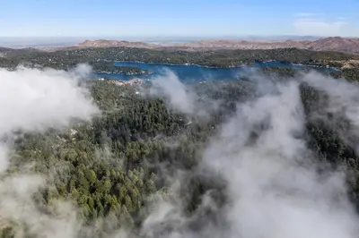 an aerial view of a forest with clouds at Retro Retreat, BBQ, Patio with Outdoor Seating! in Lake Arrowhead
