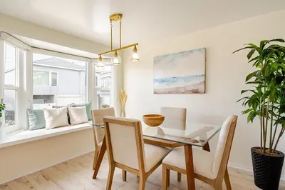a dining room with a table and chairs and a window at Amazing location, Unique Oceanfront Beach House! in Manhattan Beach