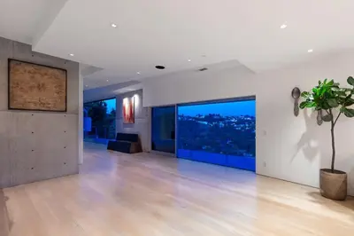 a large living room with a potted plant and large windows at Modern Villa Hollywood Hills Sanctuary in Los Angeles