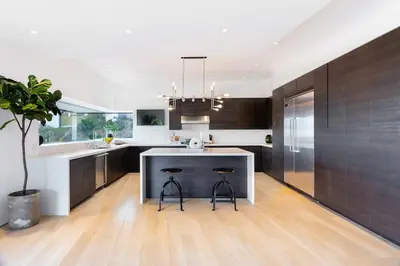 a kitchen with a island with two bar stools at Modern Villa Hollywood Hills Sanctuary in Los Angeles