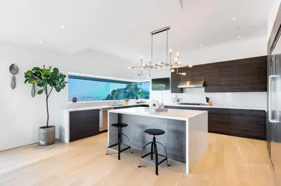 a kitchen with a counter and a island with stools at Modern Villa Hollywood Hills Sanctuary in Los Angeles