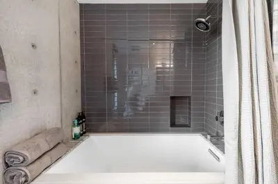 a bath tub in a bathroom with a shower at Modern Villa Hollywood Hills Sanctuary in Los Angeles