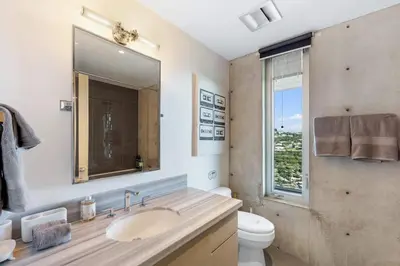 a bathroom with a sink and a toilet and a mirror at Modern Villa Hollywood Hills Sanctuary in Los Angeles