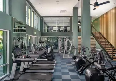 a gym with a row of treadmills and machines at Urban Chic Home 10 Min from Disneyland With Pool & GYM in Santa Ana