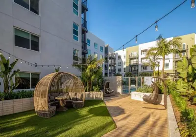 a courtyard with a gazebo and chairs in a building at Stunning Haven with Pool Gym Parking Close to Disneyland in Santa Ana