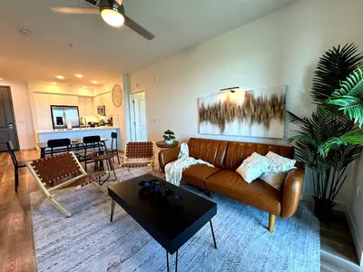 a living room with a couch and a table at Luxury Haven 10 Min From Disneyland With Pool & GYM in Santa Ana