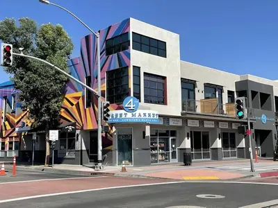 a building on the corner of a street with a traffic light at Elegant Escape 10 Min from Disneyland With Pool & GYM in Santa Ana