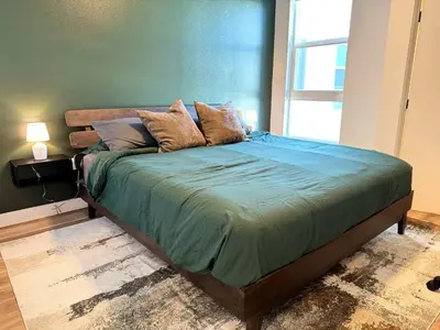 a bed with pillows on it in a bedroom at Elegant Escape 10 Min from Disneyland With Pool & GYM in Santa Ana
