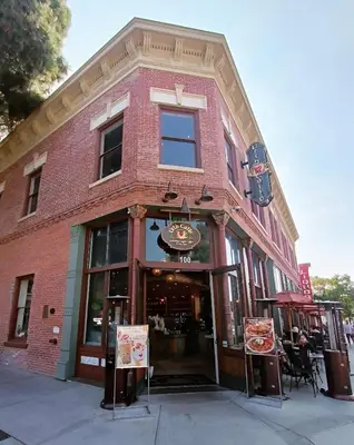 a red brick building with a pizza restaurant at Modern Retreat 10 Min from Disneyland With Pool & Gym in Santa Ana