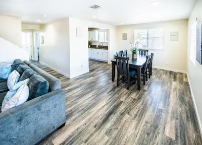 a living room and dining room with a couch and a table at Spacious 5BR 3BA Home with Free Parking and WiFi 10 Minutes to Downtown LA Perfect for Large Groups in Los Angeles