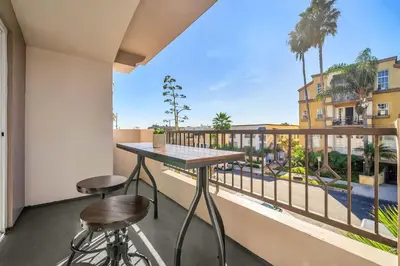a balcony with a table and two stools at Amazing & Spacious in Heart of Santa Monica- Easy Access to ALL Tourist attractions in Los Angeles