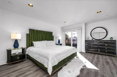 a bedroom with a large bed and a mirror at Amazing & Spacious in Heart of Santa Monica- Easy Access to ALL Tourist attractions in Los Angeles