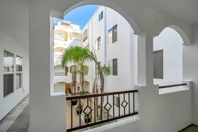 an arched window in a white building with plants at Amazing & Spacious in Heart of Santa Monica- Easy Access to ALL Tourist attractions in Los Angeles