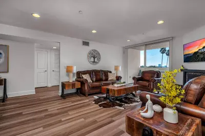 a living room with leather furniture and a fireplace at Amazing Spacious Unit in Heart of LA- Melrose district in Los Angeles
