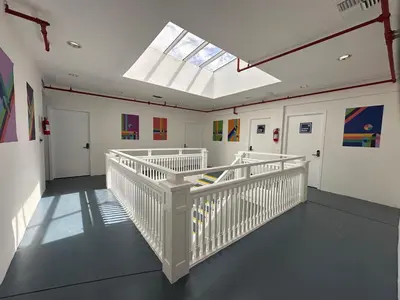 a room with a white staircase with a skylight at The Art Nook Private Rooms on Hollywood Blvd in Los Angeles
