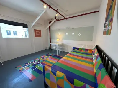 a bedroom with a colorful bed in a room at The Art Nook Private Rooms on Hollywood Blvd in Los Angeles