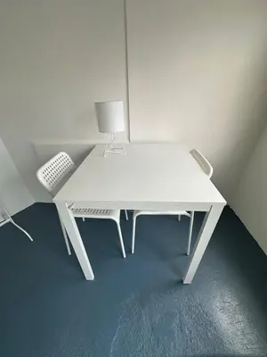 a white desk with a lamp and a chair at The Art Nook Private Rooms on Hollywood Blvd in Los Angeles