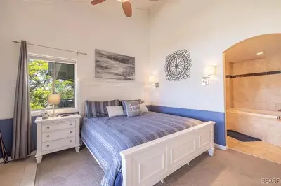 a bedroom with a bed and a bath tub at Lake Forest Shores at Big Bear Lake in Big Bear Lake