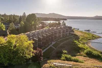 an aerial view of a building next to the water at Lake Forest Shores at Big Bear Lake in Big Bear Lake