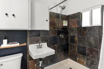 a bathroom with a sink and a toilet at Urban Farmhouse in Venice Walk to Abbot Kinney w Patio and Parking in Los Angeles