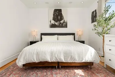 a bedroom with a large bed and two lamps at Urban Farmhouse in Venice Walk to Abbot Kinney w Patio and Parking in Los Angeles